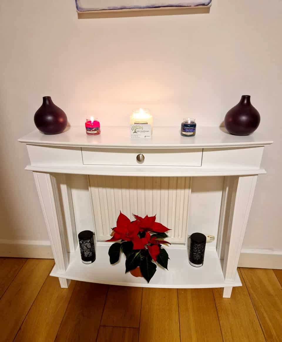 console table with curved top and lower shelf covering a radiator.