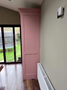 Side on view of large pink larder unit