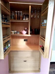 Oak drawers and shelving on large kitchen larder unit