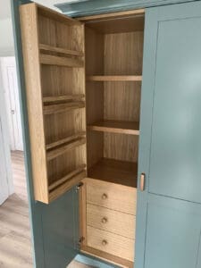 Tall kitchen with painted doors and natural oak inside.
