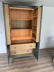 Kitchen larder unit with painted doors and Oak shelving and drawers