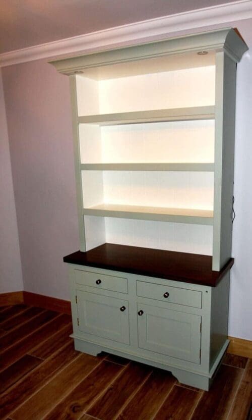 Freestanding kitchen dresser with open shelving above a cabinet with a walnut counter top