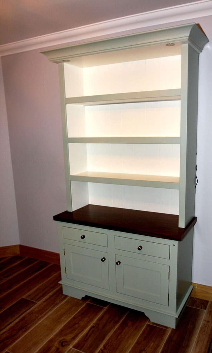 Freestanding kitchen dresser with open shelving above a cabinet with a walnut counter top