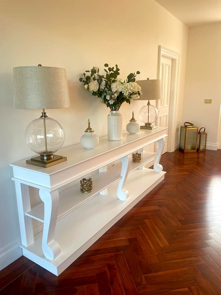 Large white console table in hallway