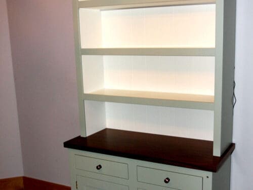 Freestanding kitchen dresser with open shelving above a cabinet with a walnut counter top