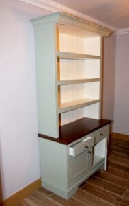 A freestanding traditional kitchen dresser with open doors